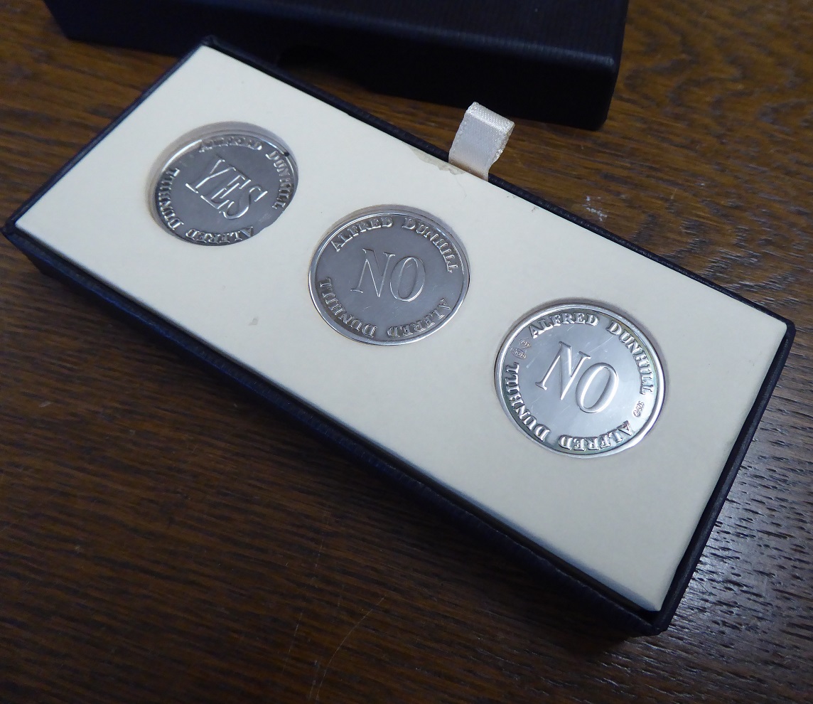 An Alfred Dunhill Yes / No Sterling Silver Coin Set