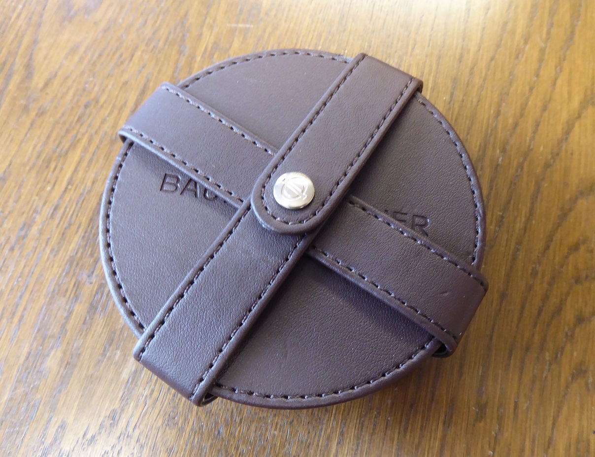 A Set Of Six Baume & Mercier Leather Coasters